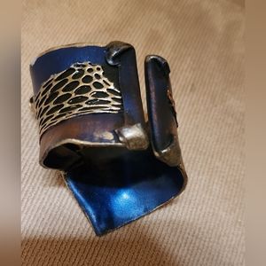 One of a kind artist made leather bracelet in blue, gold, black.